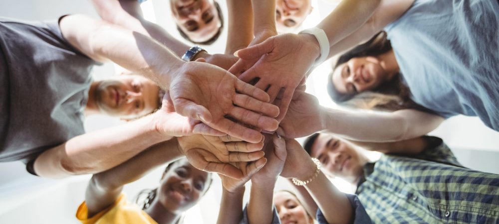 Close-up of business executives with hand stacked in office