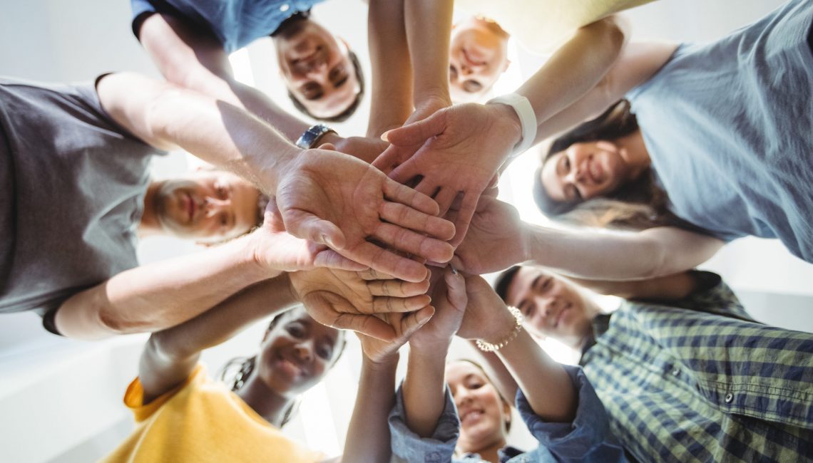 Close-up of business executives with hand stacked in office